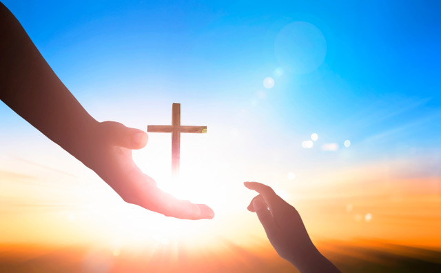 hands reaching in sky with cross in the middle